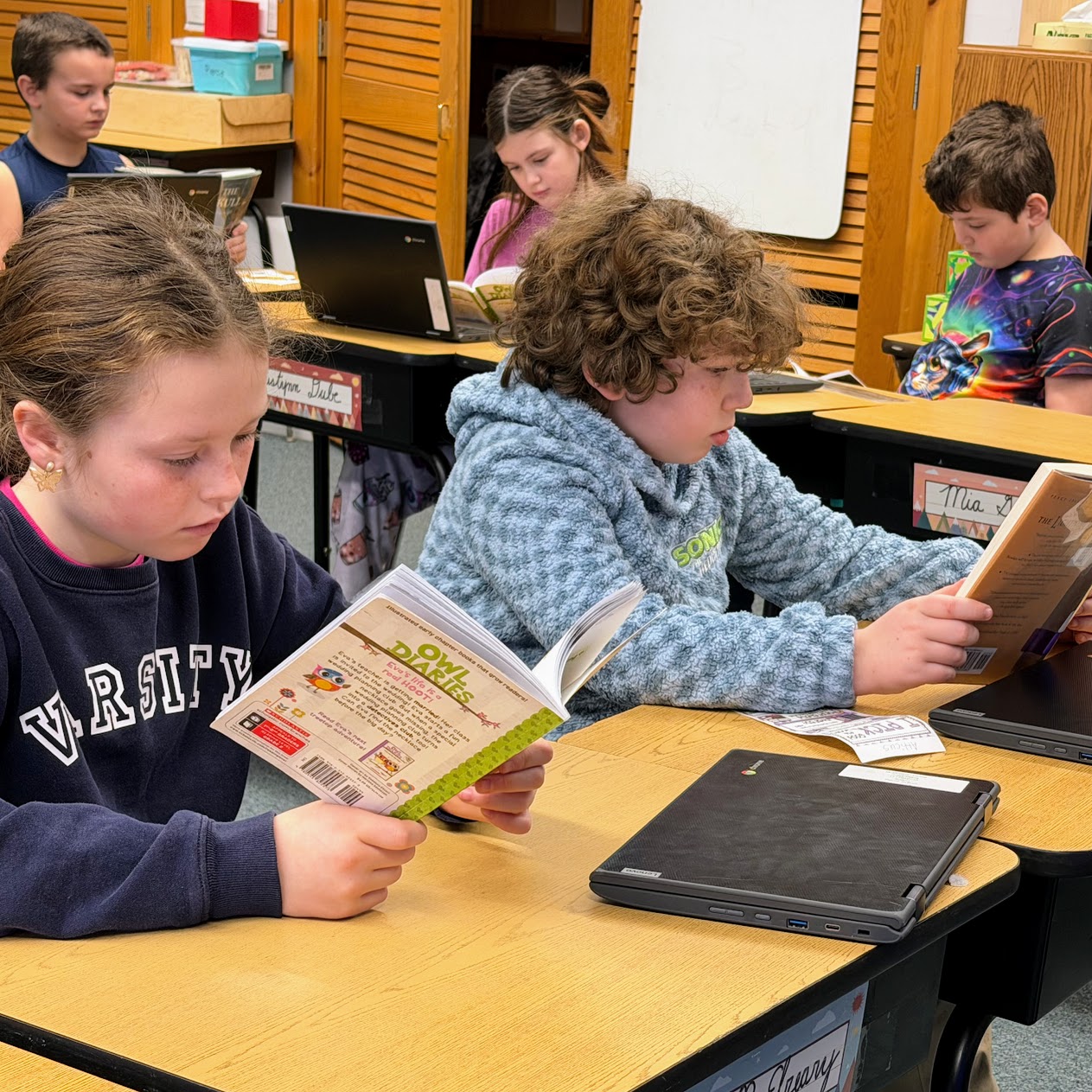 Students read at their desks. 